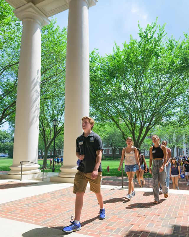 students file into Gore Hall, walking by its columns, during NSO