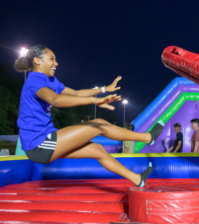 a student falls on a cushioned platform during games at Gameday 101, part of UD Welcome Days