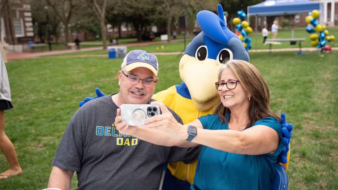 Parents take a selfie with YoUDee at Parents and Family Weekend