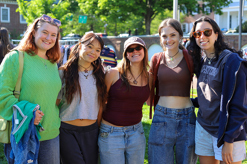 Students smiling for a group photo at the S4E Flea Market