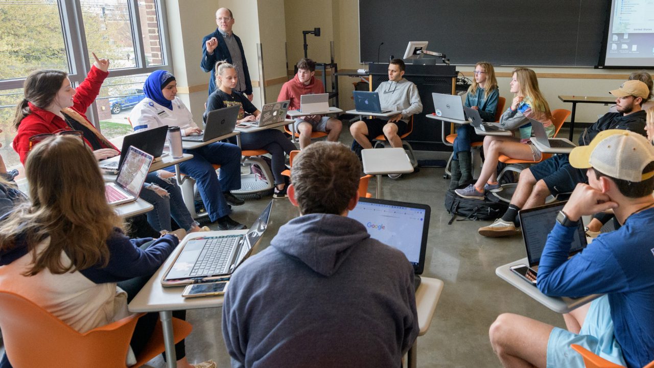 Students sitting in a circular classroom arrangement