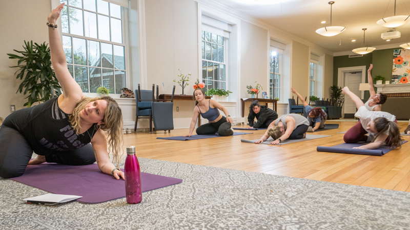 students participate in a yoga class in Warner Hall.