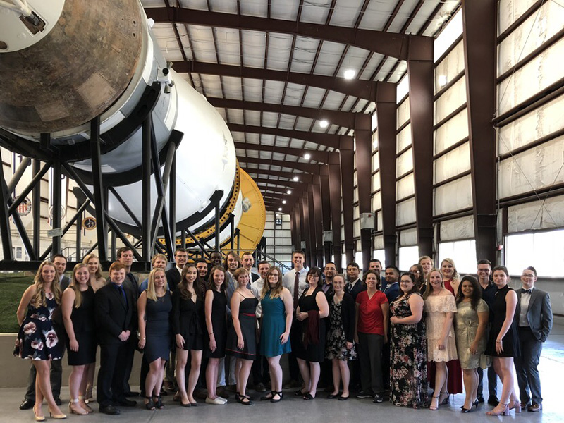 UD student Natalie Zimmerman (second from right) was an intern this summer at NASA’s Johnson Space Center in Houston. With a Saturn rocket replica in the background, the interns gathered before their traditional “Fancy Dinner,” which Zimmerman co-organized this summer. 