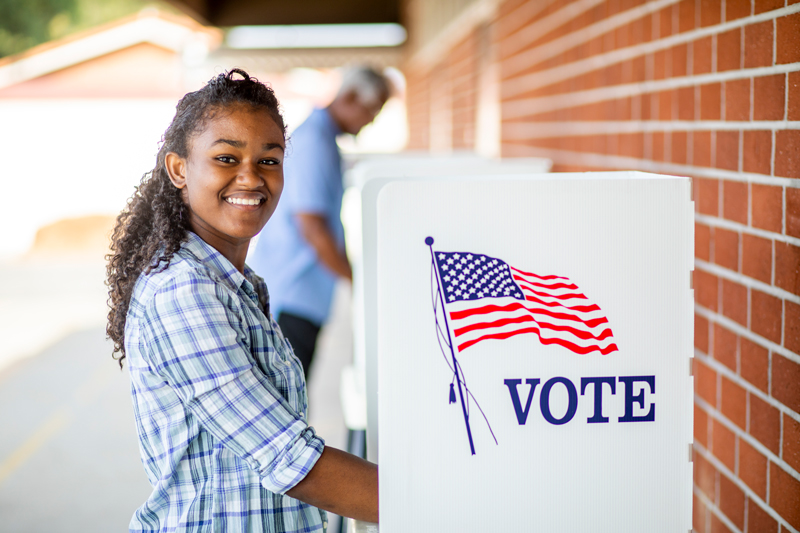 A young black girl voting on election day