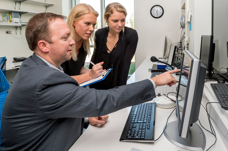 Professor Curtis Johnson (left) is pioneering a new technique to examine brain stiffness and how it relates to cognitive loss and diseases like Alzheimer’s. He is shown in this pre-pandemic photo in UD’s Center for Biomedical and Brain Imaging with doctoral student Grace McIlvaine (center) and then-undergraduate student Gabrielle Villermaux.