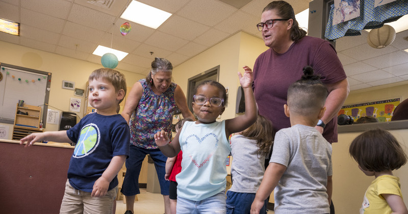 Toddlers and their teachers dance to “Baby Shark” and other children’s songs at the Early Learning Center. 