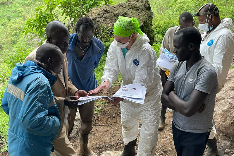 Kading reviews educational materials with local community members in Uganda. Kading hires local bat ambassadors to share information about bats and conservation.