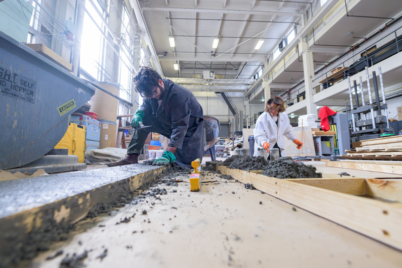 Olsen (left) and Head assemble the bricks in the Structures Lab. The bricks that are now installed in front of Du Pont Hall contain nearly 1,000 pounds of plastic waste. 