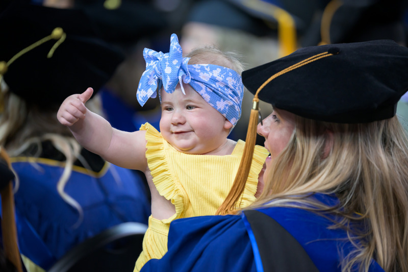 A young supporter gives a thumbs up to UD’s newest doctors.