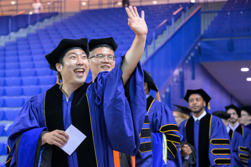 Happy waves to the crowd made the ceremony a place for memorable connections between graduates and the supportive family and friends that filled the stands.