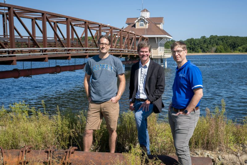 Maik Kecinski (left), Kent Messer (center), and Martin Heintzelman (right) from the UD Department of Applied Economics and Statistics stand at the Newark Reservoir. The three researchers have received a $1.5 million grant from the U.S. Army Engineer Research and Development Center to help the U.S. Army Corps of Engineers assess the economic value of what is gained or lost from the Corps’ environmental projects.