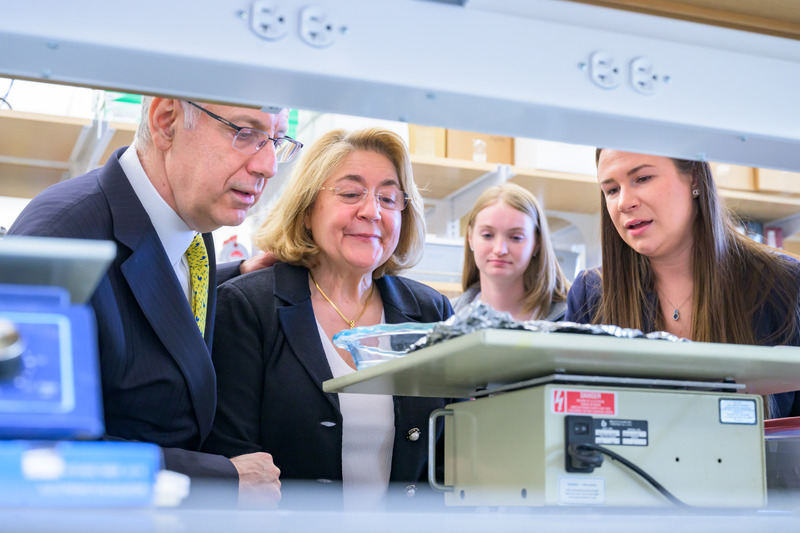 University of Delaware President Dennis Assanis and First Lady Eleni Assanis check out lab equipment in Building X as postdoctoral researcher Katrina Milbocker and Sabrina Vander Wiele, a doctoral student in biomedical engineering, explain some of their work.