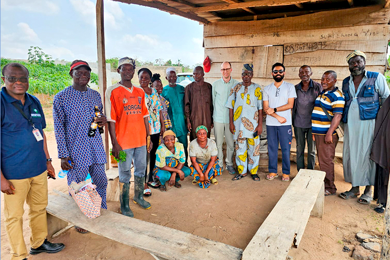 UD assistant professor Kyle Davis (center) and doctoral candidate Bhoktear Khan (center right) recently had a paper published in Sciences Advances that focuses on cropland expansion in Nigeria. Davis and Khan traveled to Nigeria to conduct fieldwork in 2024. During that time, they visited farmers' fields and interviewed farmers about their farming practices. They are pictured with a farmers’ cooperative. 