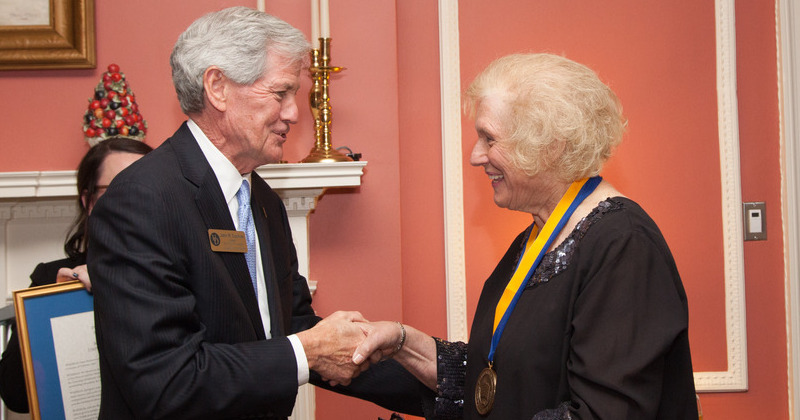 John Cochran presents Medal of Distinction to Susan Brynteson