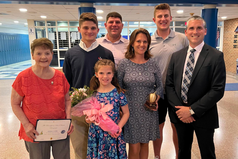 Cobb (center) after receiving Mount Pleasant Elementary School’s 2022 Teacher of the Year Award, pictured with her mother Barbara D'Aguiar-Wilson (left), husband Goodwin Cobb IV (third from left), children Goodwin V (second from right), Eddie (second from left) and Victoria (front) and Matt Auerbach (right), principal of Mount Pleasant Elementary.