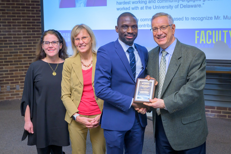Abass Muhammed, pictured with Sarah Trembanis, chair of the Faculty Senate Student and Faculty Honors committee, Provost Laura Carlson and President Dennis Assanis, received the fall 2024 Excellence in Scholarly Community Engagement for Graduate Students award.