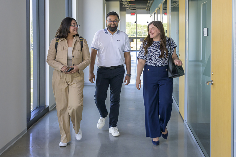 MBA students Tahseef Reza and Nabila Briste walk with Jessica Venturi, assistant director of Lerner Career Services, at UD’s FinTech Innovation Hub. With Venturi’s guidance, Briste secured a competitive Graduate Internship Program placement at Sallie Mae, while Reza earned a prestigious summer role at JPMorgan Chase.