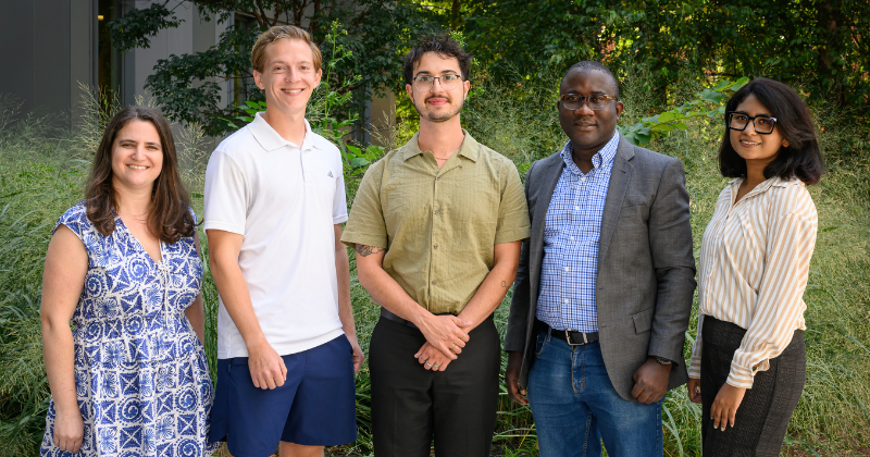 the DENIN fellows standing in front of a courtyard