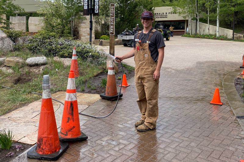 Fox waters a new perennial bed at Betty Ford Alpine Gardens.