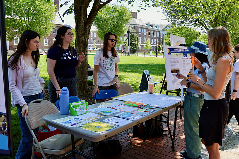 Olivia Bennis, Jennifer Barbour and Cassandra Christoffel, students in ENSC/ENVR 450 Proseminar in the Environment, a senior capstone course taught by Vaishnavi Tripuraneni, are pictured here on Earth Day informing visitors about Heat Awareness Week. 