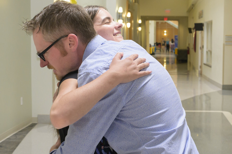 Peyton Harter (right) embraces Garrett McManus, the Good Samaritan who helped her in the minutes after the crash, at the University of Delaware, where he works as the director of catering. It is the first time they have seen each other since her crash and recovery.