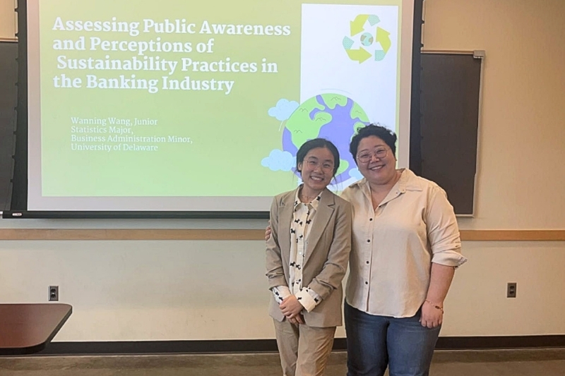 Wang speaks with her mentor, Ju-A Hwang, assistant professor in the College of Arts and Sciences. As part of the UD Summer Scholars program, Wang conducted and analyzed a survey examining how people perceive sustainability in the banking industry and how it influences their banking decisions.